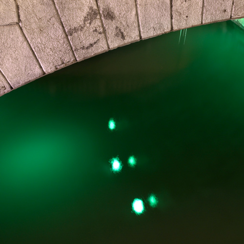 Illuminated river under Triple Bridge, Ljubljana, Slovenia.